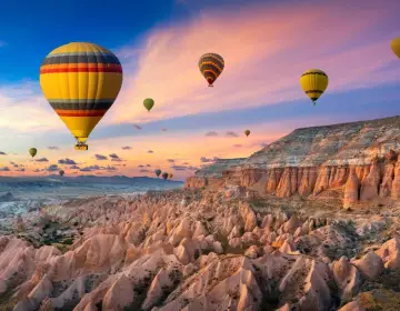 Hillside view of hot air balloons in Cappadocia