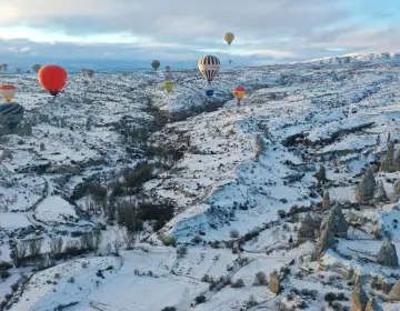 Aerial view of balloons over mountain ridge Cappadocia
