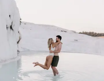 Romantic photo of couple bathing in Pamukkale white terraces