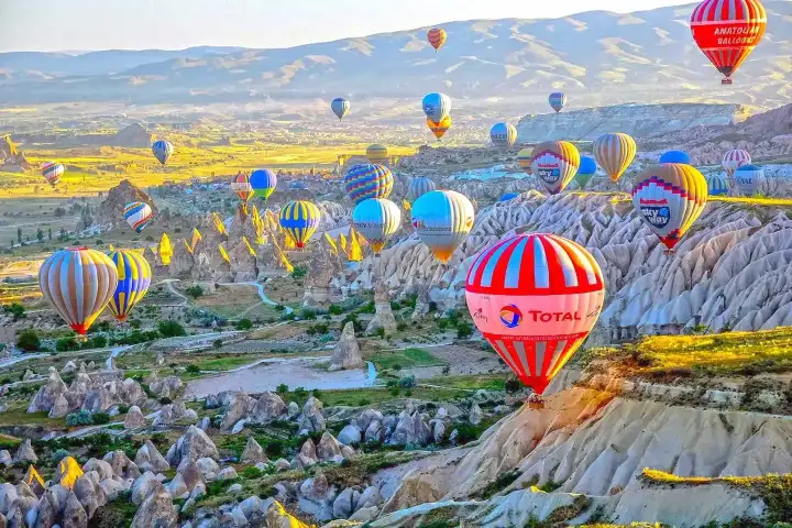 Globos aerostaticos de Cappadocia al amanecer sobre valles de chimeneas de hadas