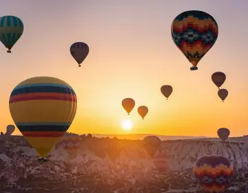 Mongolfiere in Cappadocia sopra le valli al tramonto