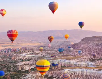 Twilight sky filled with hot air balloons in Cappadocia
